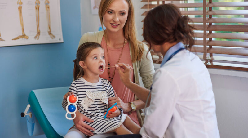 a dr checking a child